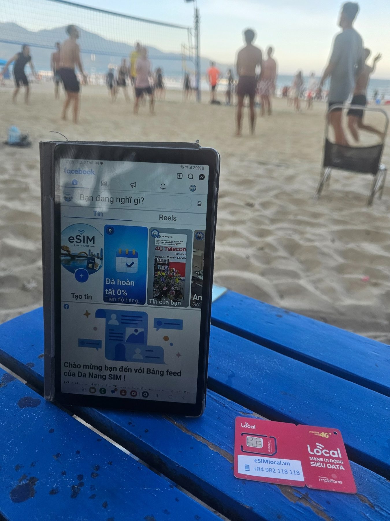 Local SIM and phone on a beach table in Da Nang